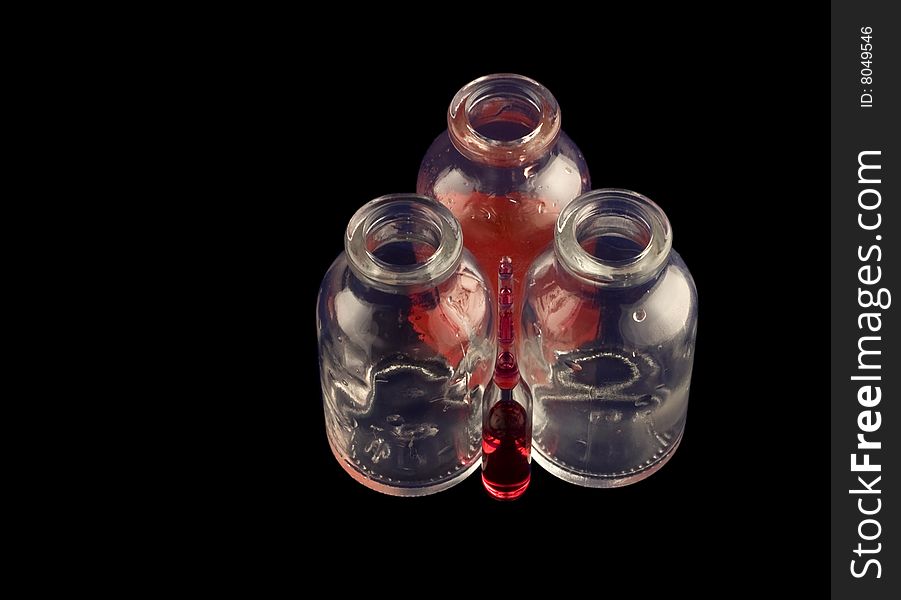 Two empty vials, one with red medicine and an ampule. Two empty vials, one with red medicine and an ampule