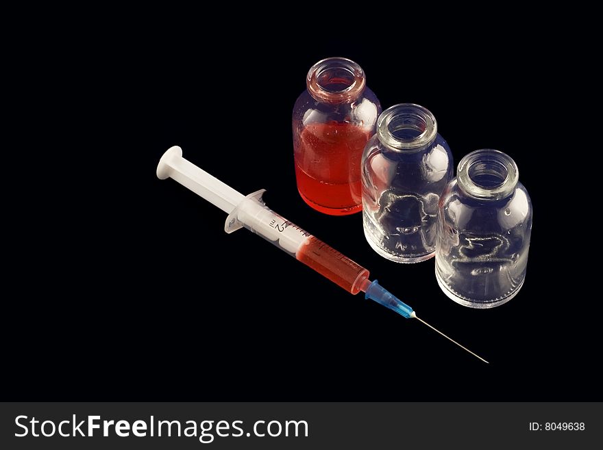 Three vials and a syringe