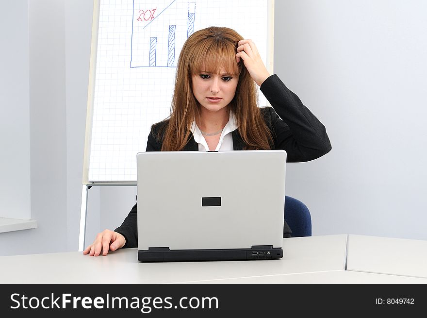 Young business woman working on a laptop.