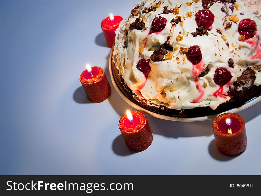 Birthday cream cake with candles around it