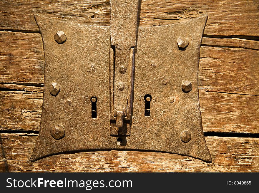 The antique iron closed lock on an old door