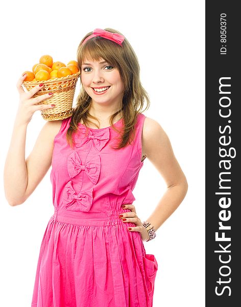 Portrait of a beautiful young woman dressed in pink with a basket full of tangerines. Portrait of a beautiful young woman dressed in pink with a basket full of tangerines