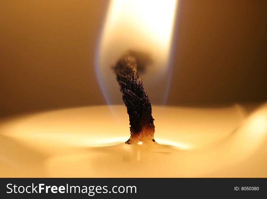 A macro closeup of a burning candle