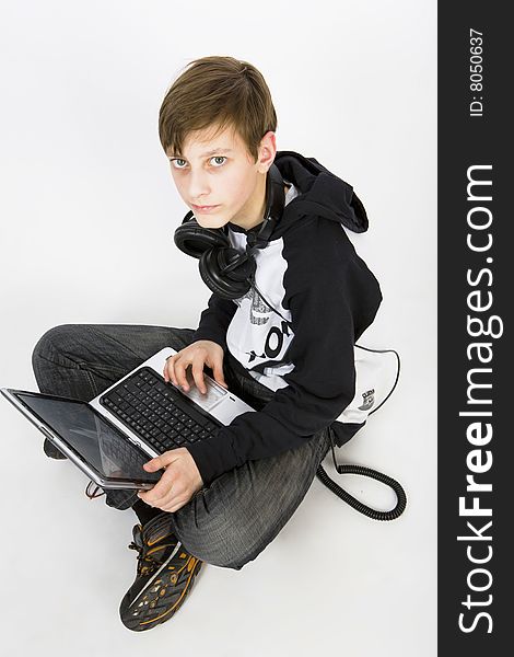 Young man with headphones and computer. Young man with headphones and computer