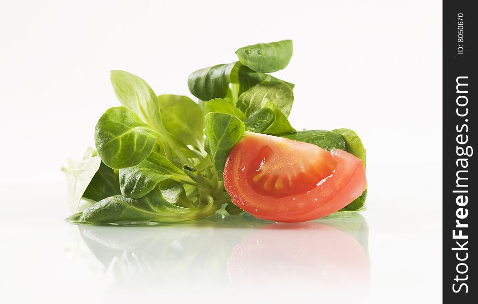 Fresh basil leaves and tomato on white background