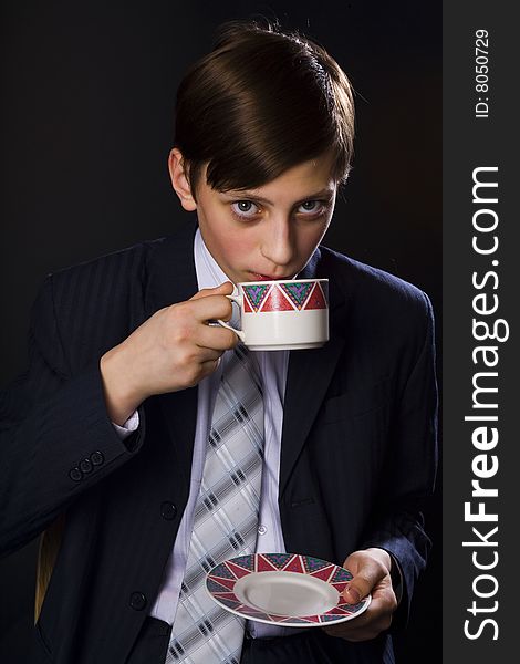 Young businessmen in suit and tie with cup of tea