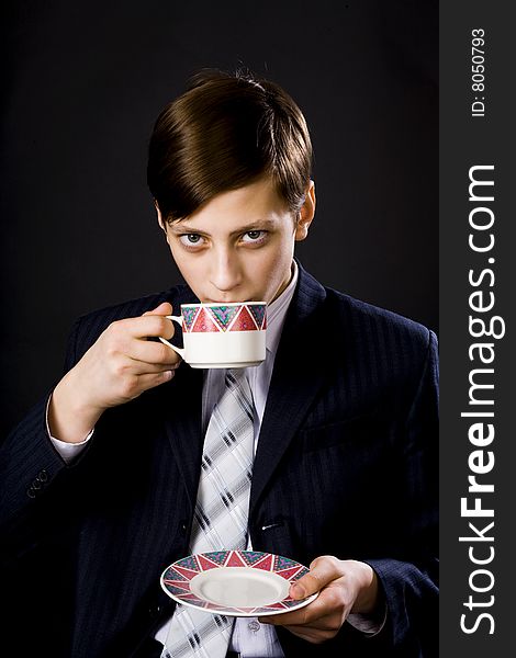 Young businessmen in suit and tie with cup of tea