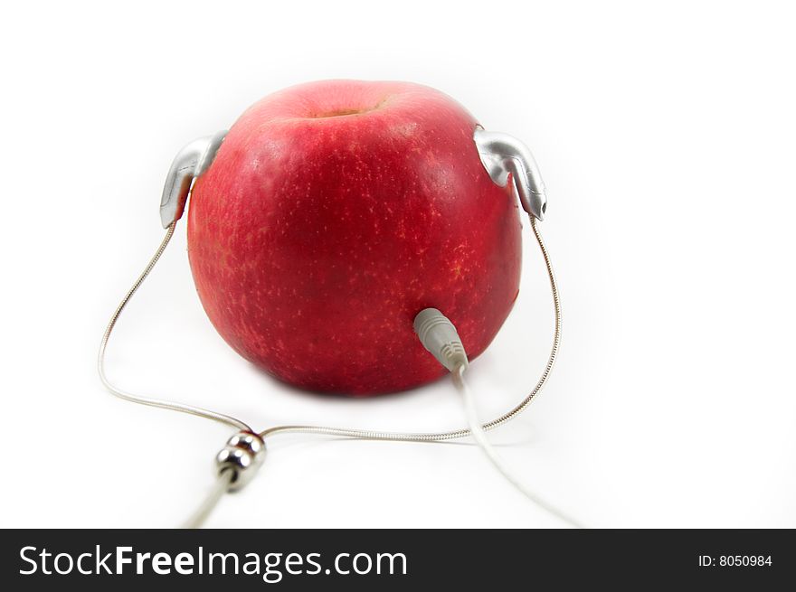 Red apple with earphones like player isolated on white. Red apple with earphones like player isolated on white