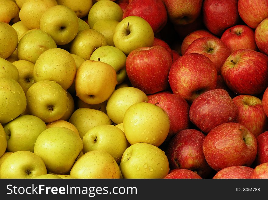 A close up photo of a bunch of red and yellow apples