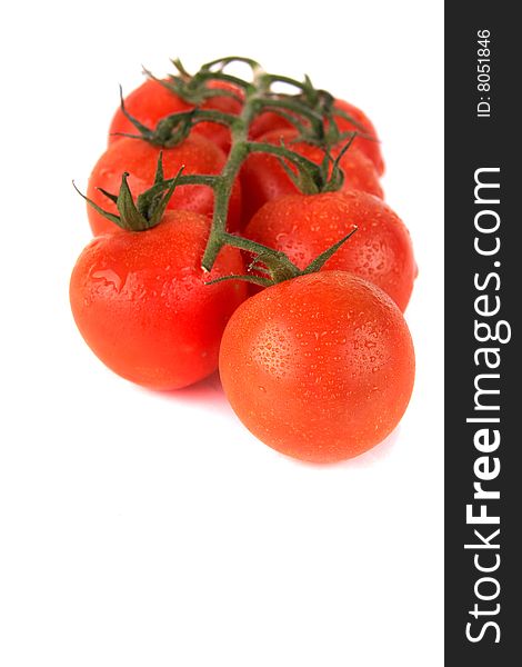 Macroshot of a bunch of tomatoes with drops of water. Isolated over white background. Lot of copyspace. Macroshot of a bunch of tomatoes with drops of water. Isolated over white background. Lot of copyspace.