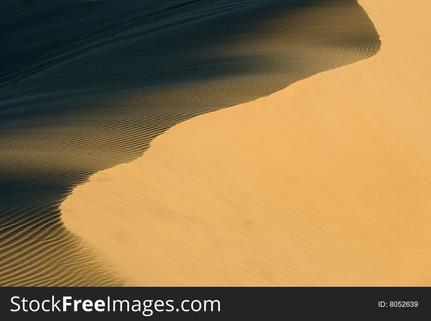 Stockton sand dunes in Anna Bay, NSW, Australia. Sand ripples detail with dramatic shadows. Taken in low light conditions.