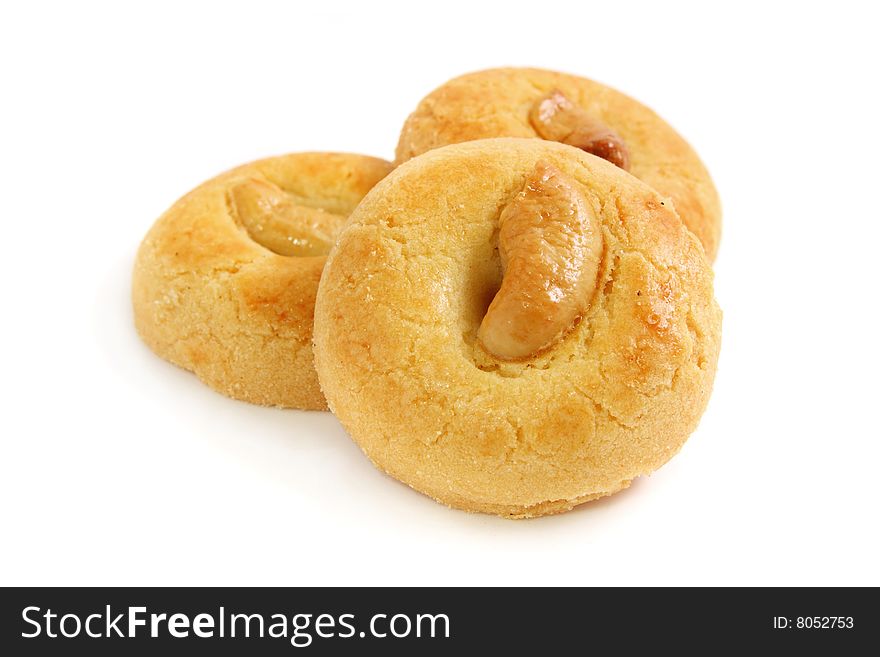 Three pieces of kidney bean cookies stacked over white background.