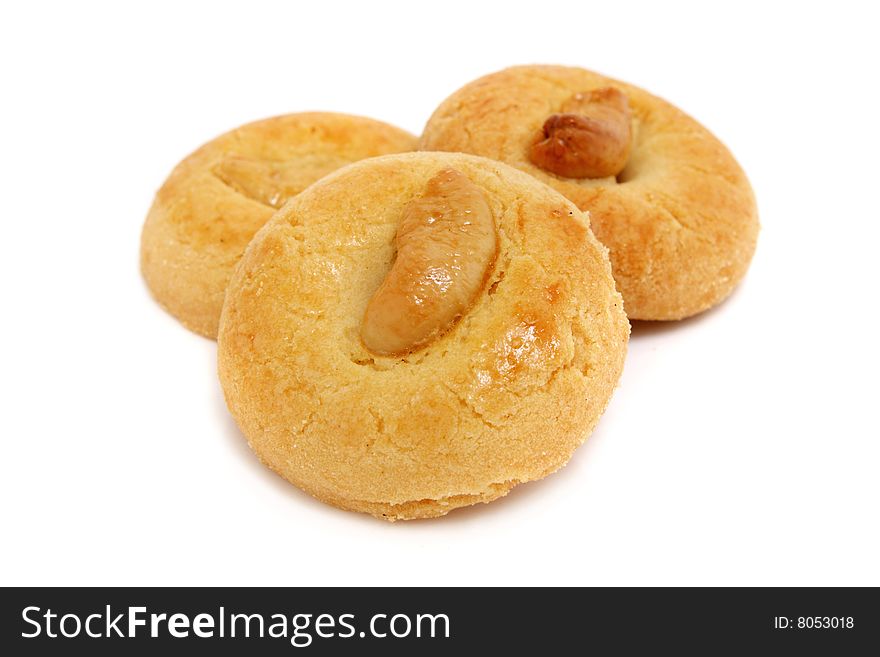 Three pieces of kidney bean cookies stacked over white background.