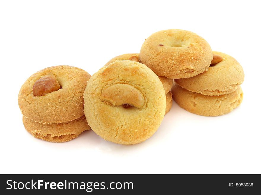 Many pieces of kidney bean cookies stacked over white background.