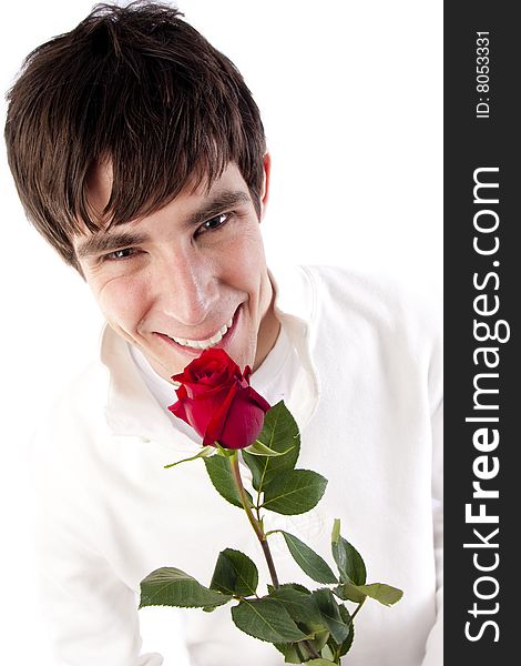 A young man holds a rose and smiles