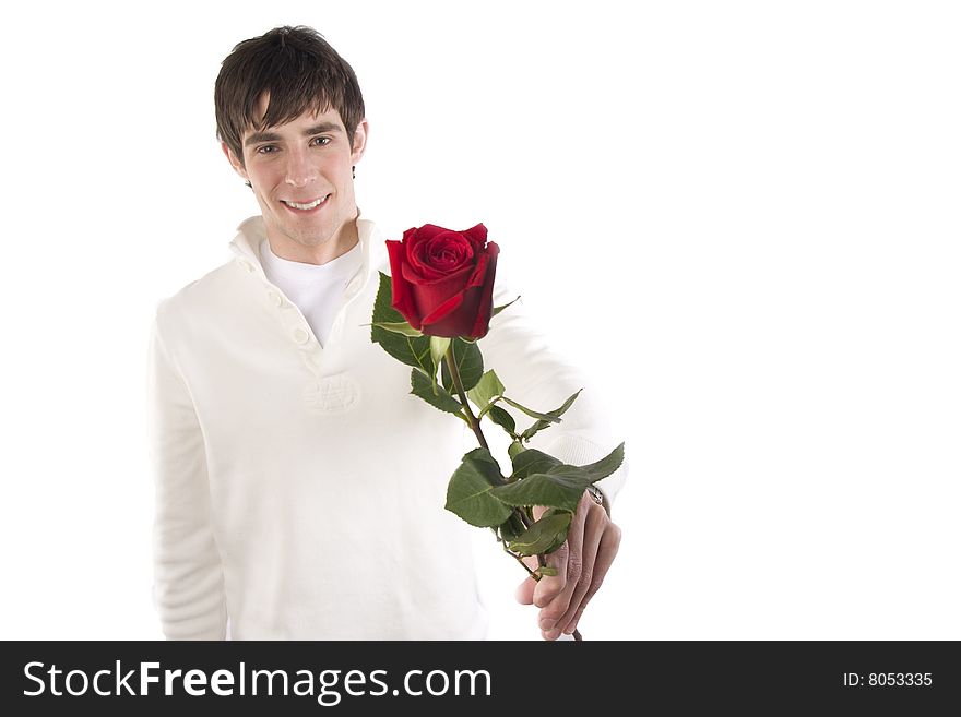 A young man holds a rose and smiles