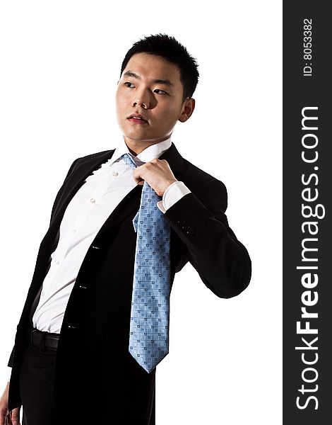 Asian man in formal attire untying tie