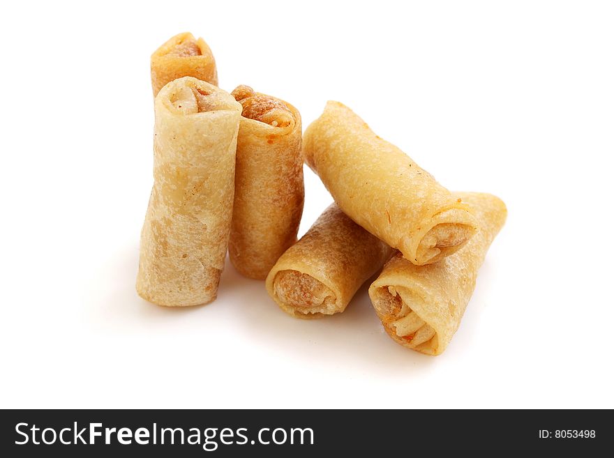 Fried prawn scrolls standing over white background.