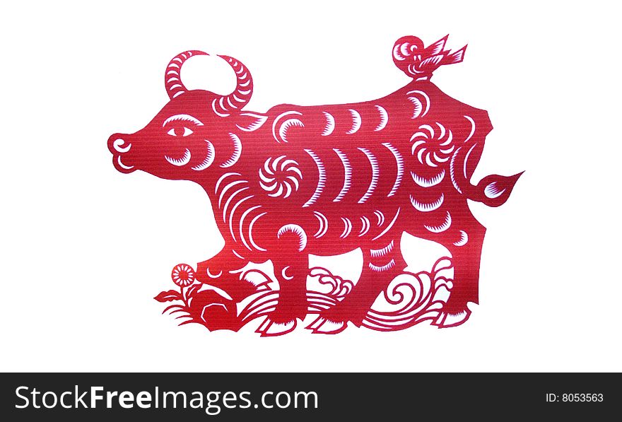 The Chinese red paper cutting of an ox and bird. The Chinese red paper cutting of an ox and bird.