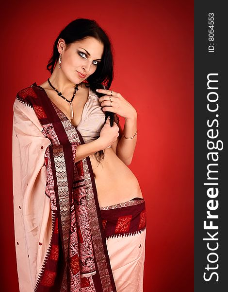 Young beautiful brunette in the indian national dress. Young beautiful brunette in the indian national dress