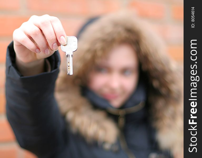 Hand holds a key (key in focus)