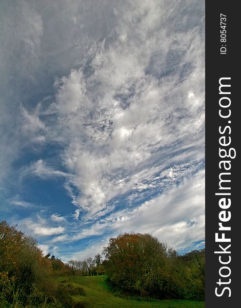 Cumulus clouds over field in autumn. Cumulus clouds over field in autumn