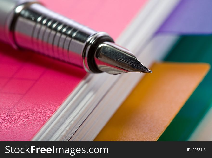Stock photo: an image of a fountain pen on a notebook