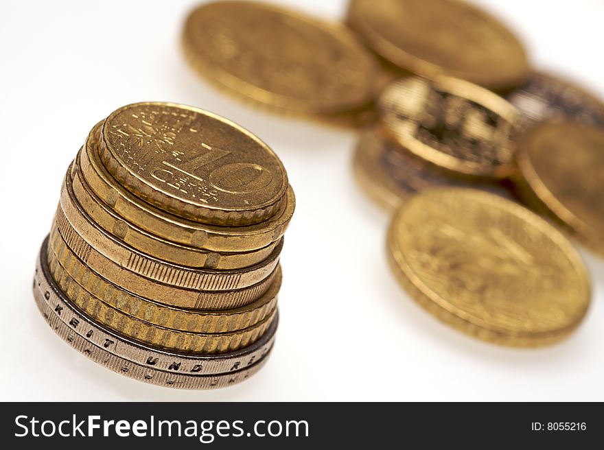 A pile of euro coins on a white background