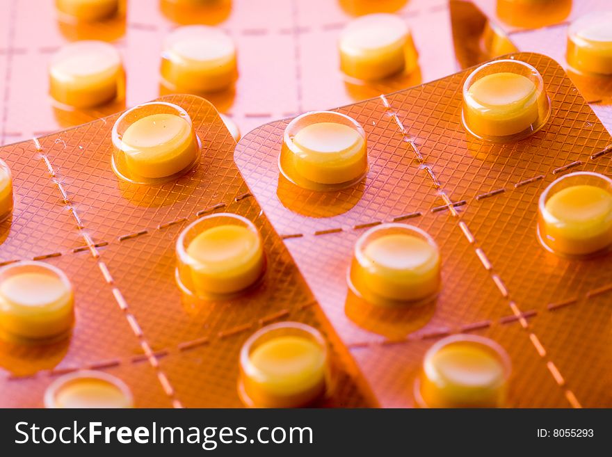 Stock photo: health theme: an image of orange tablets in blisters closeup