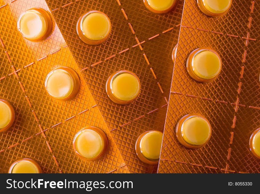 Stock photo: health theme: an image of orange pills in blister closeup