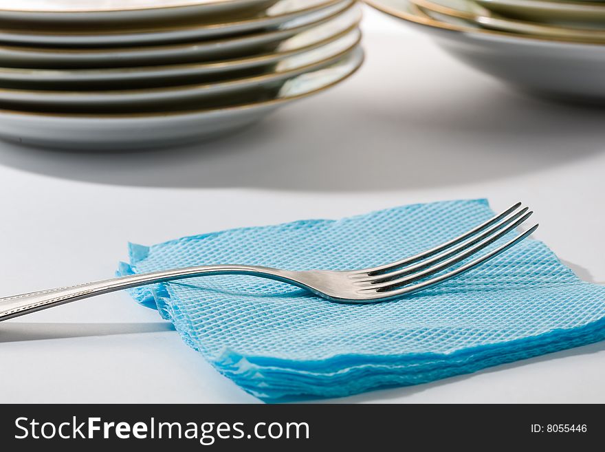 Stock photo: an image of silver fork on blue napkin