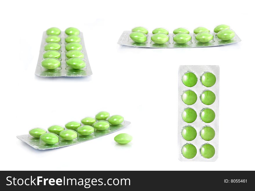 Packs of green tablets isolated on white