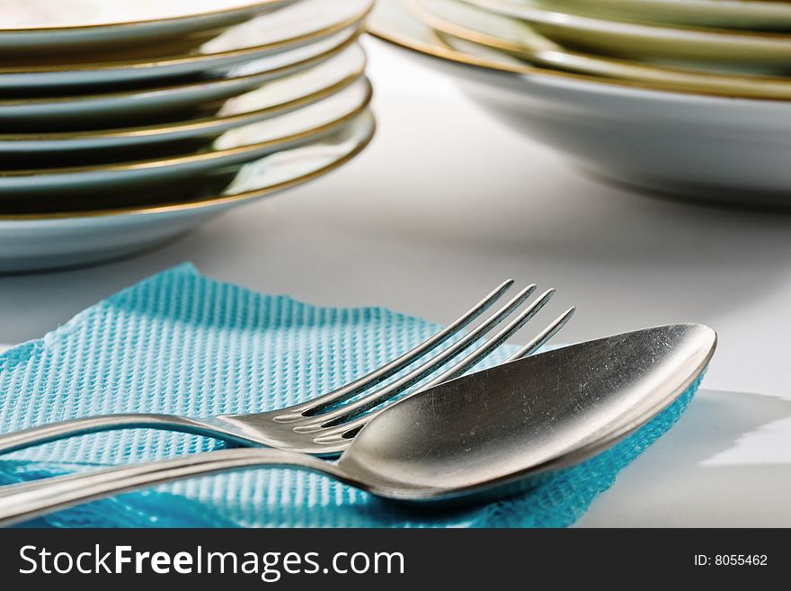 Stock photo: an image of silver spoon and fork on blue napkin