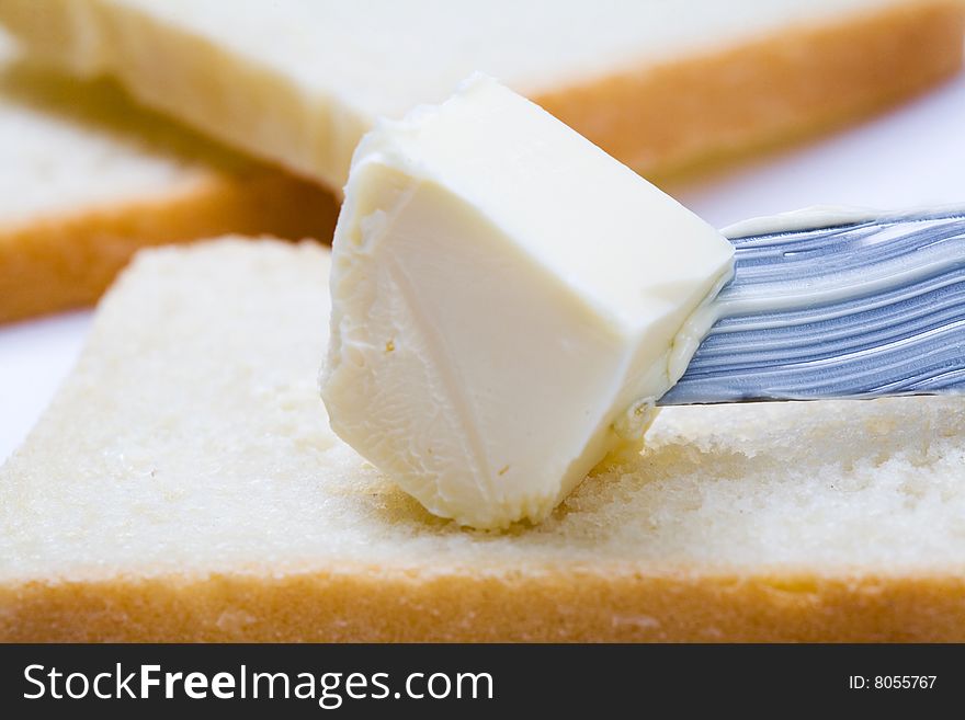Stock photo: an image of fresh butter on a knife and  bread. Stock photo: an image of fresh butter on a knife and  bread