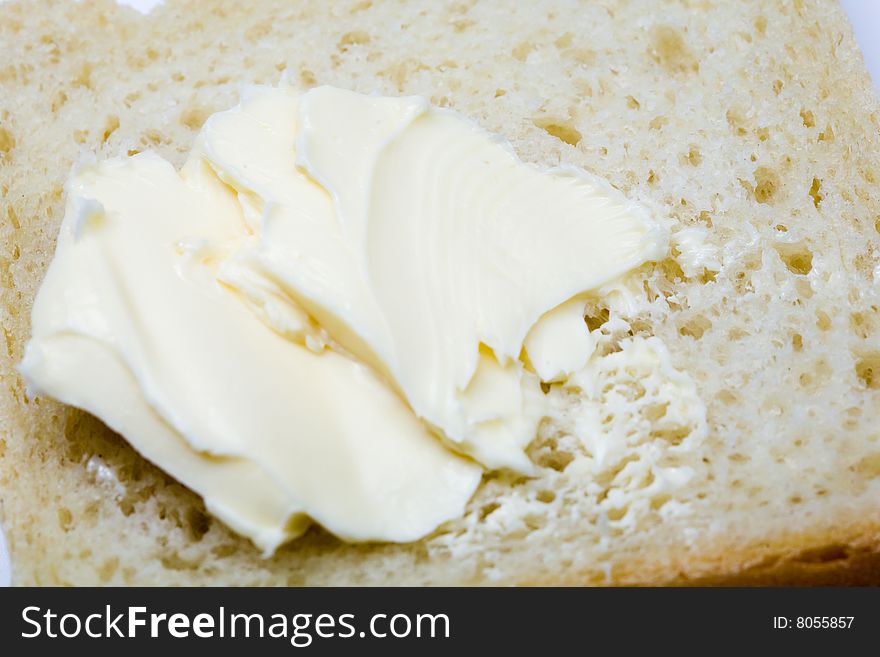 Stock photo: an image of yellow fresh butter on bread