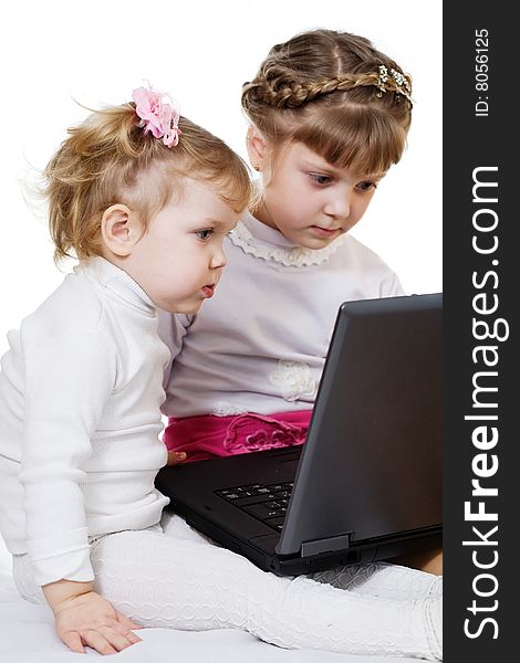 Stock photo: an image of two little girls with laptop. Stock photo: an image of two little girls with laptop