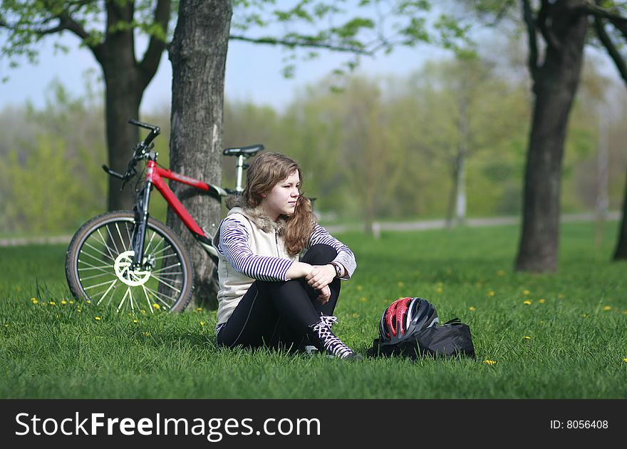 Young Lady Cycling In The Park