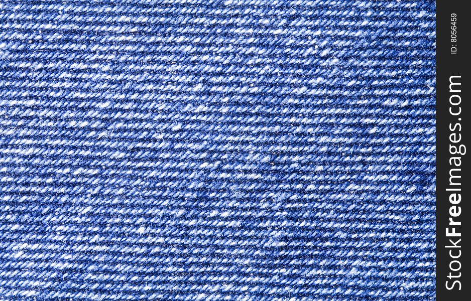 A close-up of the texture of blue jeans fabric. A close-up of the texture of blue jeans fabric