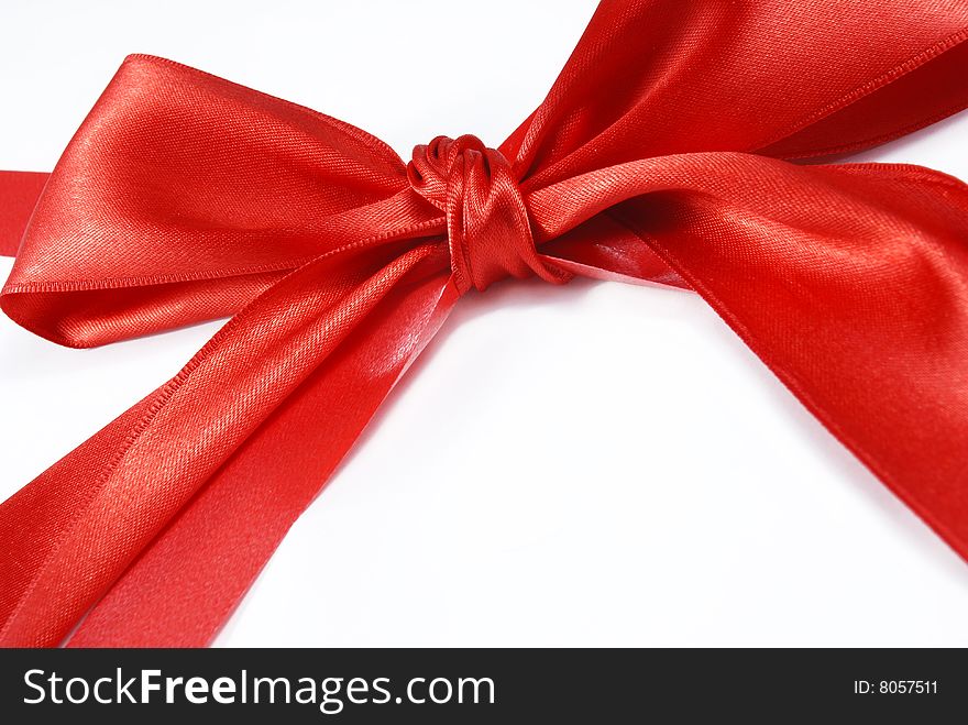 Red holiday bow on white background