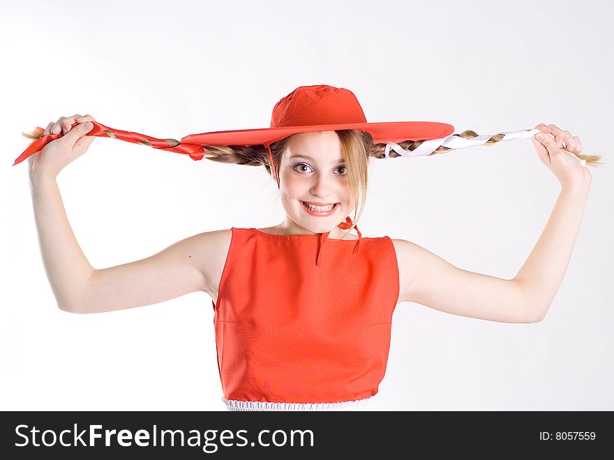 Joking girl with pigtails in red hat