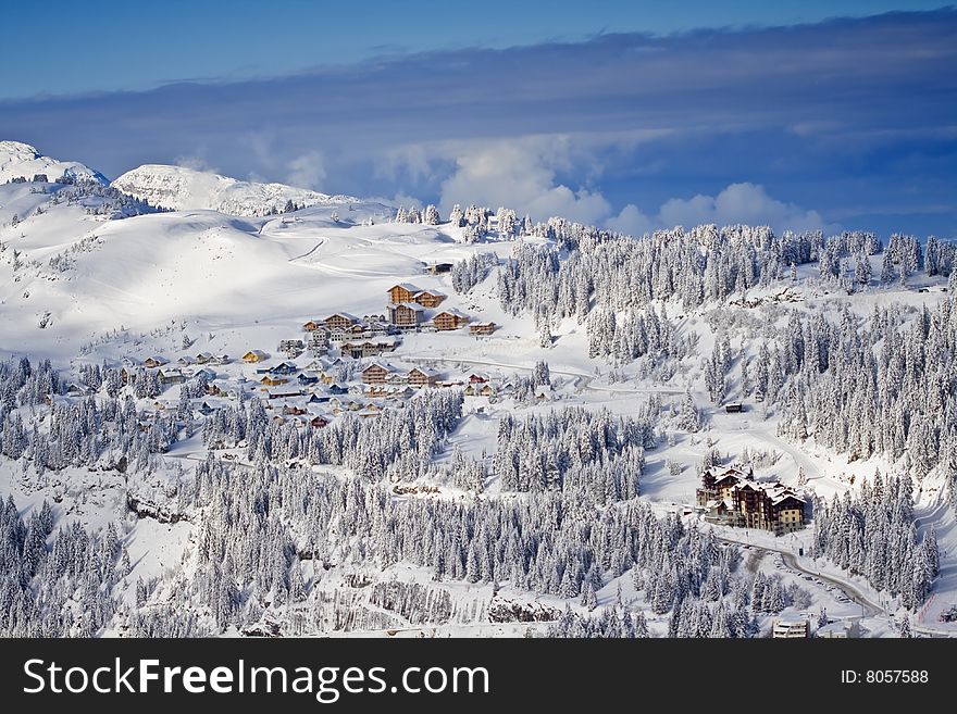 Snow covered mountain side with buildings