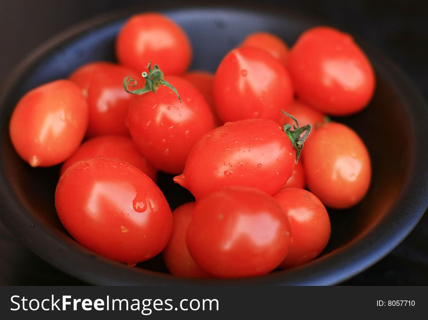 Tomatoes isolated on black background