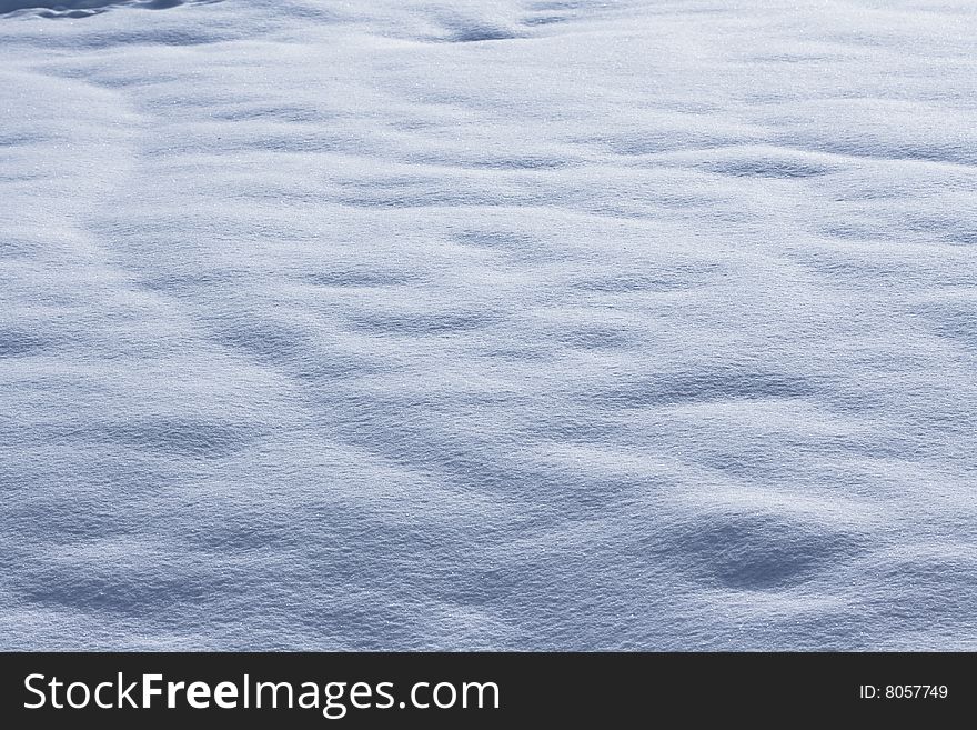A simple view of an expanse of undulating snow. A simple view of an expanse of undulating snow