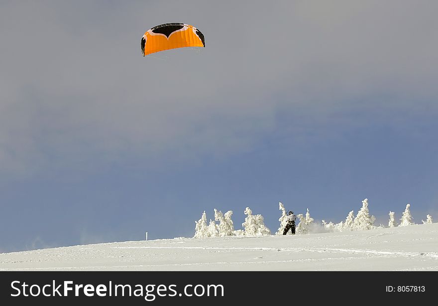 Skier is skiing with parachute. Skier is skiing with parachute