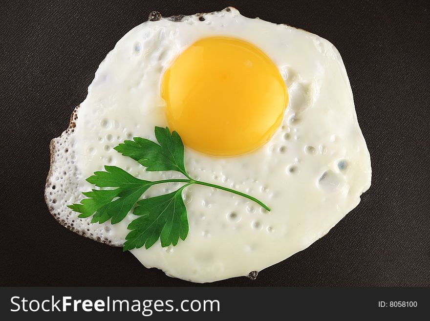 Egg with yolk and parsley bunch