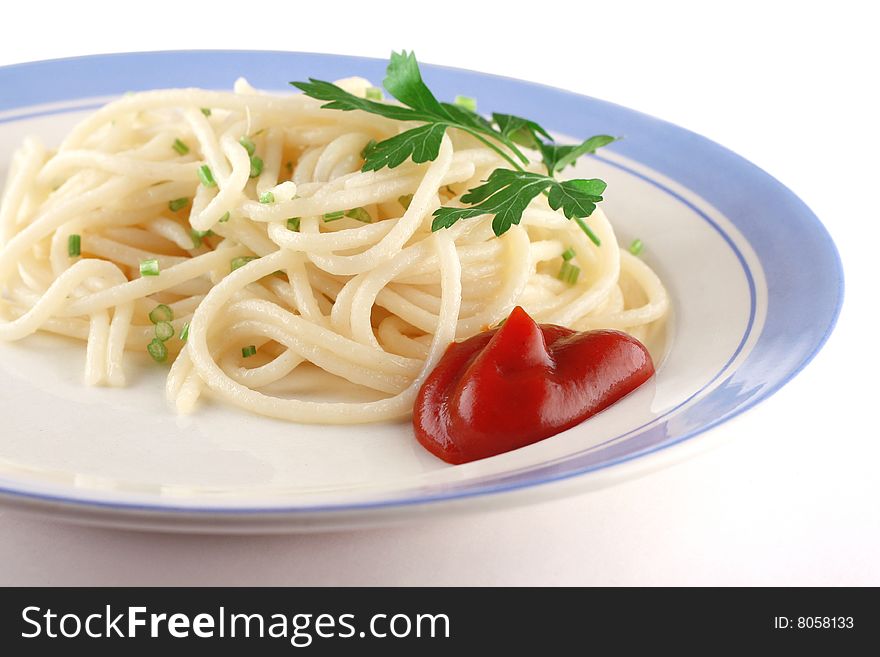 Spaghetti on a dish with parsley and ketchup