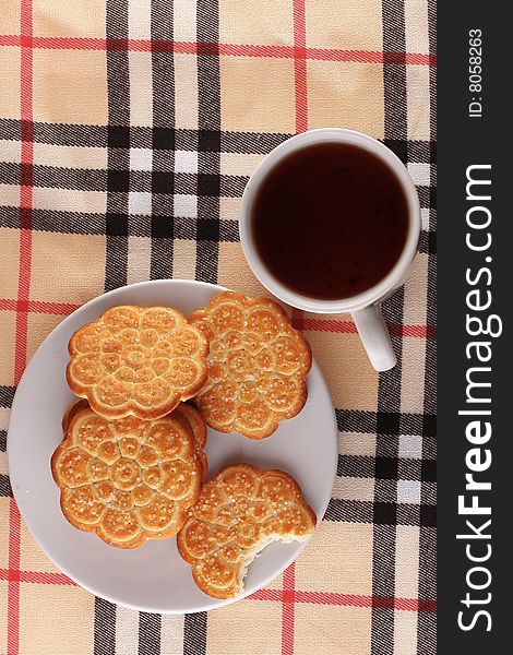 Tea in white cup with cakes