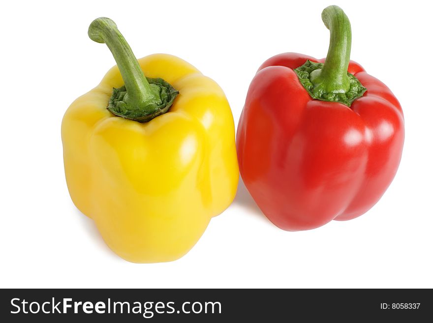 Red and yellow peppers are isolated on a white background