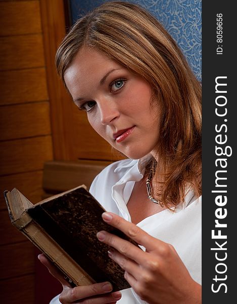 Beautiful woman in white shirt holding book. Beautiful woman in white shirt holding book