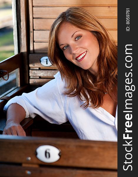 Smiling young woman traveling by train